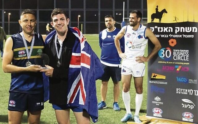 Daniel Ferrai (left), the great-great-grandson of William Cooper, presents team Israel Blue's Eitan Potash with the William Cooper Medal. In the background are AFL Israel co-founders Ido Schnitzer (left) and Shir Shalev. Daniel Ferrai (left), the great-great-grandson of William Cooper, presents team Israel Blue's Eitan Potash with the William Cooper Medal. In the background are AFL Israel co-founders Ido Schnitzer (left) and Shir Shalev.
