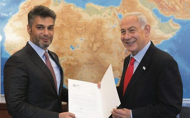 Prime Minister Benjamin Netanyahu receives an invitation to the COP28 climate summit in November in Dubai from Mohamed Al Khaja, the UAE ambassador to Israel. Photo: Amos Ben Gershom/GPO Prime Minister Benjamin Netanyahu receives an invitation to the COP28 climate summit in November in Dubai from Mohamed Al Khaja, the UAE ambassador to Israel. Photo: Amos Ben Gershom/GPO