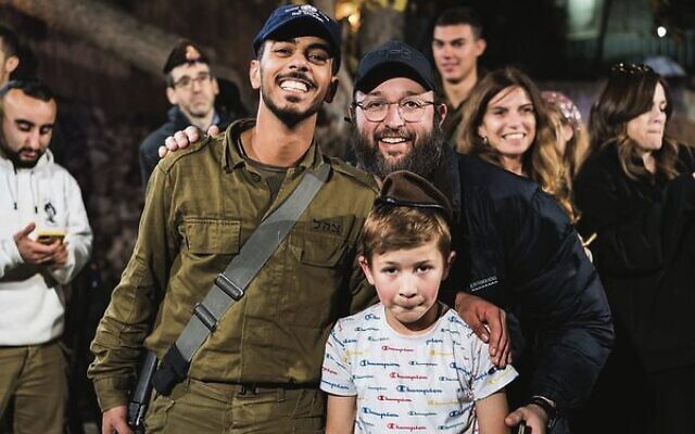 Rabbi Rabin (with his son, Eli) celebrates with soldiers at the bar mitzvah of his cousin. Rabbi Rabin (with his son, Eli) celebrates with soldiers at the bar mitzvah of his cousin.