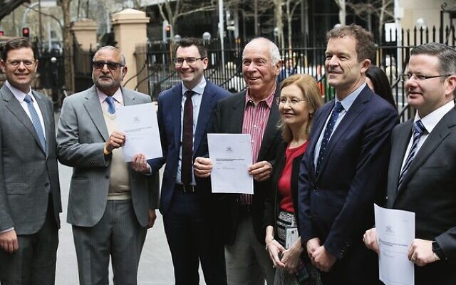 From left: former JBD president Lesli Berger, Hindu Council of Australia national vice president Surinder Jain, JBD CEO Darren Bark, Holocaust survivor Eddy Boas, former Vaucluse MP Gabrielle Upton, then Attorney-General Mark Speakman and former Minister for Multiculturalism Mark Coure after the Bill banning Nazi symbols was passed in 2022. Photo: Noel Kessel. From left: former JBD president Lesli Berger, Hindu Council of Australia national vice president Surinder Jain, JBD CEO Darren Bark, Holocaust survivor Eddy Boas, former Vaucluse MP Gabrielle Upton, then Attorney-General Mark Speakman and former Minister for Multiculturalism Mark Coure after the Bill banning Nazi symbols was passed in 2022. Photo: Noel Kessel.