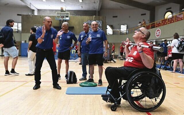 A British athlete is cheered on by Israeli teammates and staff in the third Veterans Games in Tel Aviv on May 29. Photo: Beit Halochem UK A British athlete is cheered on by Israeli teammates and staff in the third Veterans Games in Tel Aviv on May 29. Photo: Beit Halochem UK