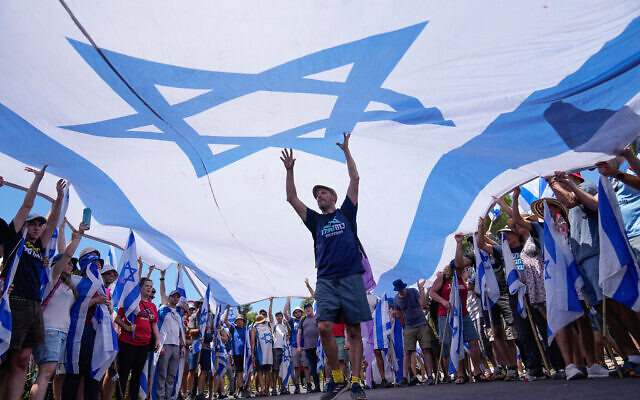 Demonstrators wave a large Israeli flag during a protest against the government outside the Knesset in Jerusalem, Monday, July 24, 2023 Photo: AP Photo/Ohad Zwigenberg Demonstrators wave a large Israeli flag during a protest against the government outside the Knesset in Jerusalem, Monday, July 24, 2023 Photo: AP Photo/Ohad Zwigenberg