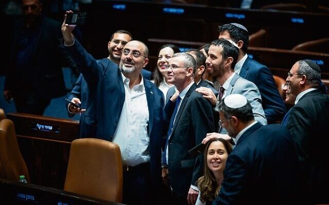 Coalition lawmakers crowd around Justice Minister Yariv Levin to take a celebratory selfie in the Knesset, as they pass the first of the coalition's judicial overhaul laws, July 24, 2023. Photo: Yonatan Sindel/Flash90 Coalition lawmakers crowd around Justice Minister Yariv Levin to take a celebratory selfie in the Knesset, as they pass the first of the coalition's judicial overhaul laws, July 24, 2023. Photo: Yonatan Sindel/Flash90