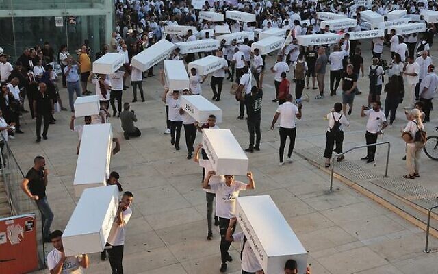 Activists in Tel Aviv march with symbolic coffins denouncing the violent crimes against Arab communities.
Photo: Jack Guez / AFP Activists in Tel Aviv march with symbolic coffins denouncing the violent crimes against Arab communities.
Photo: Jack Guez / AFP