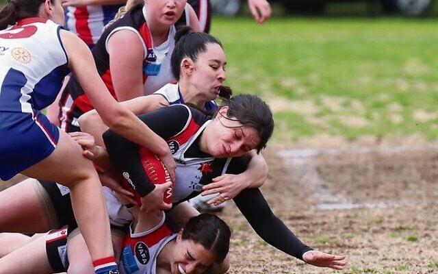 Jess Marget (with the ball) amid a pile of players. Photos: Peter Haskin Jess Marget (with the ball) amid a pile of players. Photos: Peter Haskin