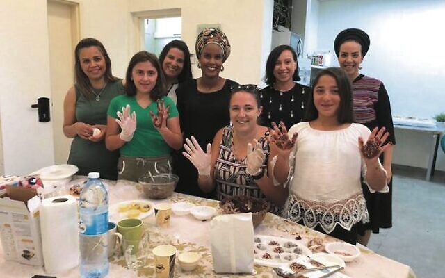 Shayna (fifth from left) volunteers with children in the youth villages, a UIA project supported through Australian donations. Shayna (fifth from left) volunteers with children in the youth villages, a UIA project supported through Australian donations.