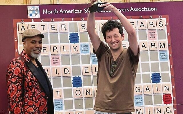 David Eldar raises the 2023 world Scrabble championship trophy. Photo: NASPA David Eldar raises the 2023 world Scrabble championship trophy. Photo: NASPA