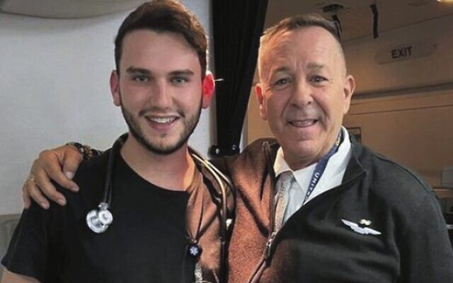 Yossi Meyer (left) with one of the flight attendants. Yossi Meyer (left) with one of the flight attendants.
