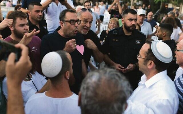 Secular and Orthodox activists clash after the religious Rosh Yehudi group set up a gender divider made of Israeli flags in defiance of a municipality decision at a public prayer service in Dizengoff Square, Tel Aviv on Yom Kippur. Photo: Tomer Neuberg/Flash 90 Secular and Orthodox activists clash after the religious Rosh Yehudi group set up a gender divider made of Israeli flags in defiance of a municipality decision at a public prayer service in Dizengoff Square, Tel Aviv on Yom Kippur. Photo: Tomer Neuberg/Flash 90