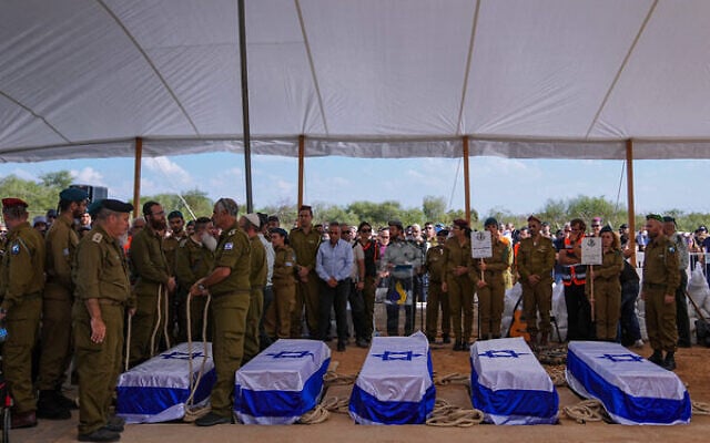 Mourners gather around the five coffins of the Kotz family, who were killed in Hamas's assault, during their funeral in Gan Yavne, Israel, October 17, 2023. Photo: Ohad Zwigenberg/ AP Mourners gather around the five coffins of the Kotz family, who were killed in Hamas's assault, during their funeral in Gan Yavne, Israel, October 17, 2023. Photo: Ohad Zwigenberg/ AP