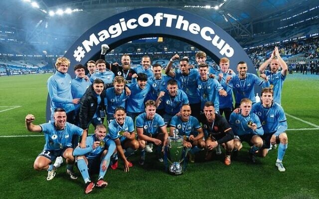 Top: Jake Girdwood-Reich (left) and Kealey Adamson holding the 2023 Australia Cup trophy. Bottom: 2023 Australia Cup final winners Sydney FC. Photos: Jaime Castaneda Top: Jake Girdwood-Reich (left) and Kealey Adamson holding the 2023 Australia Cup trophy. Bottom: 2023 Australia Cup final winners Sydney FC. Photos: Jaime Castaneda