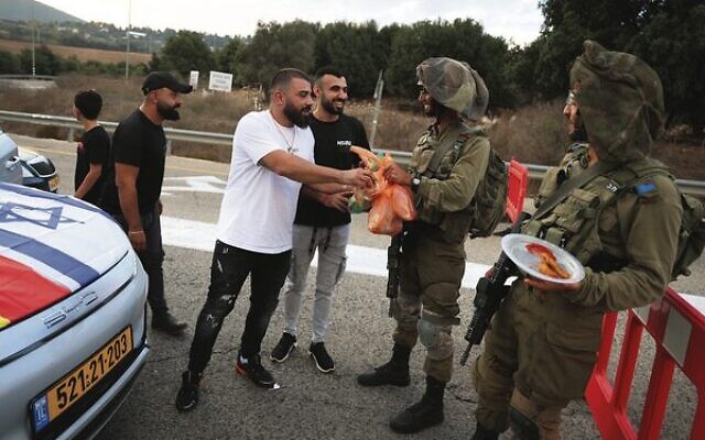 Druze residents hand out food to Israeli soldiers near the Lebanon border. Photo: David Cohen/Flash90 Druze residents hand out food to Israeli soldiers near the Lebanon border. Photo: David Cohen/Flash90