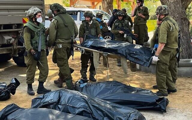 Soldiers prepare bodies in Kfar Aza. Photo: Oren Rosenfeld Soldiers prepare bodies in Kfar Aza. Photo: Oren Rosenfeld