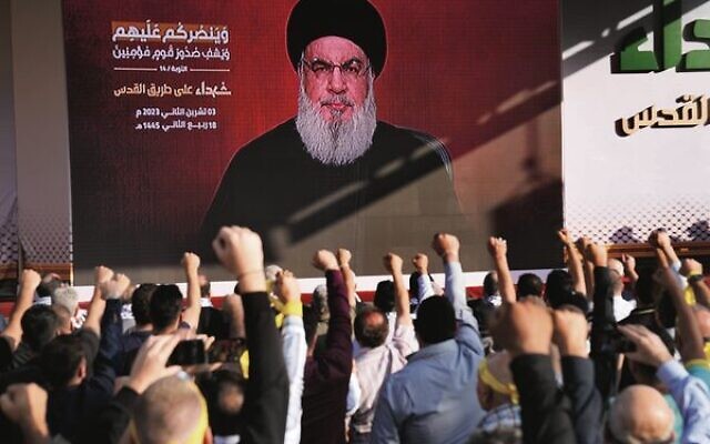 Hezbollah supporters raise their fists and cheer as leader Hassan Nasrallah gives a speech via a video link on Friday, November 3.
Photo: AP Photo/Hussein Malla Hezbollah supporters raise their fists and cheer as leader Hassan Nasrallah gives a speech via a video link on Friday, November 3.
Photo: AP Photo/Hussein Malla