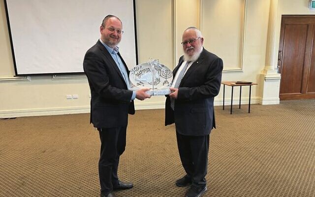 Rabbi Moshe Kahn (left) received a presentation from Rabbi Philip Heilbrunn. Rabbi Moshe Kahn (left) received a presentation from Rabbi Philip Heilbrunn.