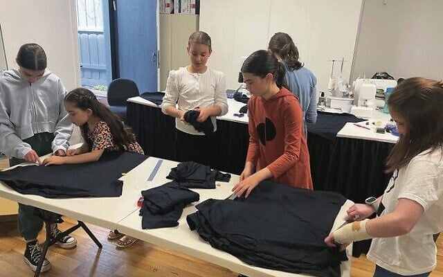 Alana Hersh's sewing students making tzitzit in her workroom. Alana Hersh's sewing students making tzitzit in her workroom.