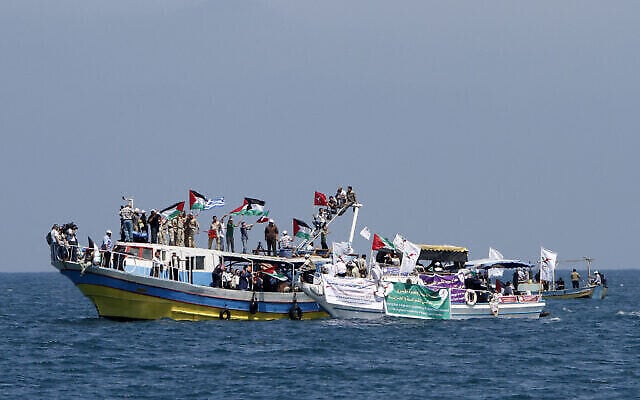 FILE: Palestinians waving national flags wait aboard small boats off the port of Gaza City on May 30, 2010, to greet the so-called 'Freedom Flotilla.' (The Times of Israel: MAHMUD HAMS / AFP) FILE: Palestinians waving national flags wait aboard small boats off the port of Gaza City on May 30, 2010, to greet the so-called 'Freedom Flotilla.' (The Times of Israel: MAHMUD HAMS / AFP)