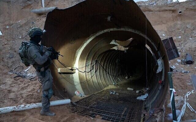 A soldier stands at the entrance to a large Hamas tunnel found near the Erez border crossing in the northern Gaza Strip, in a handout image published December 17, 2023. (The Times of Israel: Israel Defense Forces) A soldier stands at the entrance to a large Hamas tunnel found near the Erez border crossing in the northern Gaza Strip, in a handout image published December 17, 2023. (The Times of Israel: Israel Defense Forces)