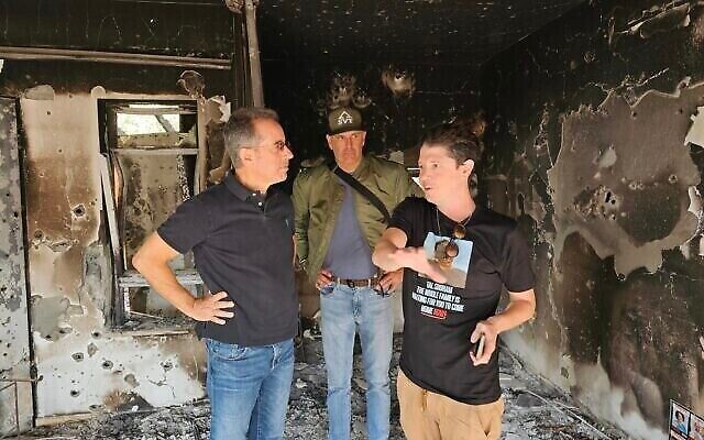 Jerry Seinfeld (left) tours Kibbutz Be'eri on December 19, 2023. (The Times of Israel: Noam Lanir/Facebook) Jerry Seinfeld (left) tours Kibbutz Be'eri on December 19, 2023. (The Times of Israel: Noam Lanir/Facebook)