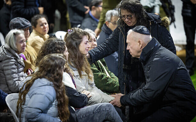 Ashira Grinberg, wife of Lt. Col. Tomer Grinberg, the Commander of the Golani Brigade's 13th Battalion, is comforted by Defense Minister Yoav Galant during his funeral at the Mount Herzl Military Cemetery in Jerusalem on December 13, 2023, Grinberg was killed in battle along with several soldiers in Shejaiya, Gaza Strip. (The Times of Israel: Yonatan Sindel/Flash90) Ashira Grinberg, wife of Lt. Col. Tomer Grinberg, the Commander of the Golani Brigade's 13th Battalion, is comforted by Defense Minister Yoav Galant during his funeral at the Mount Herzl Military Cemetery in Jerusalem on December 13, 2023, Grinberg was killed in battle along with several soldiers in Shejaiya, Gaza Strip. (The Times of Israel: Yonatan Sindel/Flash90)