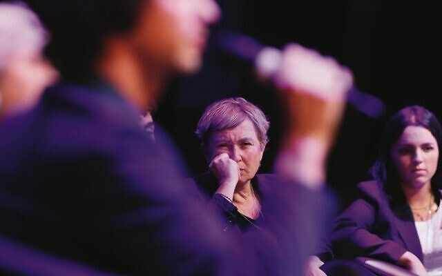 Iris Haim, mother of hostage Yotam Haim, listens as Eilon Kotler tells how his beloved kibbutz Kfar Aza was decimated at the BringThemHomeNow: Hear Their Stories event in Melbourne last week. Photo: Peter Haskin Iris Haim, mother of hostage Yotam Haim, listens as Eilon Kotler tells how his beloved kibbutz Kfar Aza was decimated at the BringThemHomeNow: Hear Their Stories event in Melbourne last week. Photo: Peter Haskin