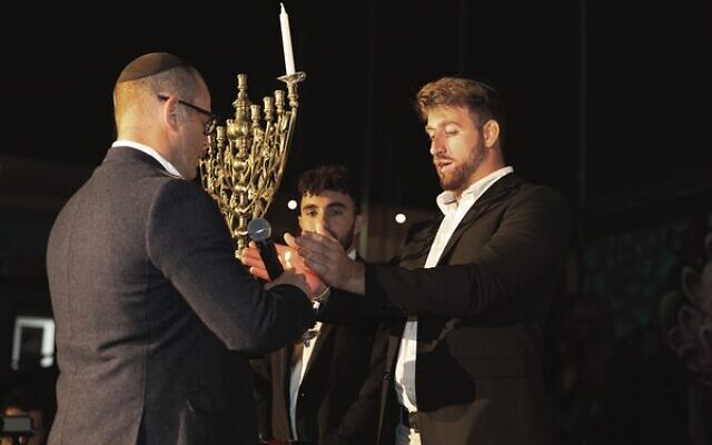 From left: Rabbi Gad Krebs, Ofir Tamir, and Amit Parpara light a candle at the Lights of Hope event. Photo: Vicki Lauren Photography From left: Rabbi Gad Krebs, Ofir Tamir, and Amit Parpara light a candle at the Lights of Hope event. Photo: Vicki Lauren Photography