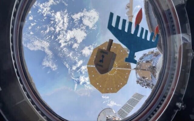 A dreidel spins in zero gravity in front of a makeshift menorah aboard the International Space Station in a video shared by NASA Astronaut Jasmine Moghbeli on December 8, 2023. (The Times of Israel: Twitter screenshot, used in accordance with Clause 27a of the Copyright Law) A dreidel spins in zero gravity in front of a makeshift menorah aboard the International Space Station in a video shared by NASA Astronaut Jasmine Moghbeli on December 8, 2023. (The Times of Israel: Twitter screenshot, used in accordance with Clause 27a of the Copyright Law)