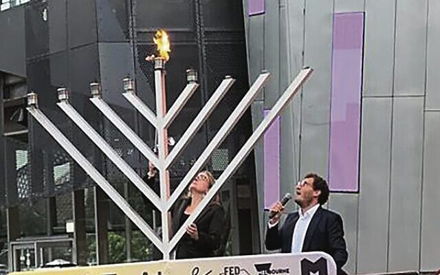 Premier Jacinta Allan lights the menorah at Pillars of Light as Rabbi Gabi Kaltmann recites the brachot. Premier Jacinta Allan lights the menorah at Pillars of Light as Rabbi Gabi Kaltmann recites the brachot.