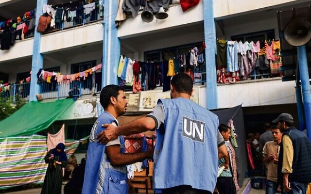 Workers at an UNRWA-run school that has been converted into a shelter for displaced Palestinians in Khan Younis. Photo: Mahmud Hams / AFP Workers at an UNRWA-run school that has been converted into a shelter for displaced Palestinians in Khan Younis. Photo: Mahmud Hams / AFP