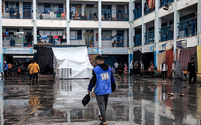 A man walks with a vest bearing the logo of the UN at a school run by UNRWA in Rafah in the southern Gaza Strip on November 14, 2023. (The Times of Israel: Said Khatib/AFP) A man walks with a vest bearing the logo of the UN at a school run by UNRWA in Rafah in the southern Gaza Strip on November 14, 2023. (The Times of Israel: Said Khatib/AFP)