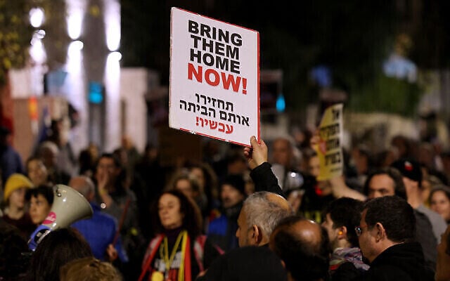 Demonstrators hold up signs during a rally to demand the release of hostages held by the Hamas terror group, near the Prime Minister's Residence in Jerusalem on January 22, 2024. (The Times of Israel: Ahmad Gharabli/AFP) Demonstrators hold up signs during a rally to demand the release of hostages held by the Hamas terror group, near the Prime Minister's Residence in Jerusalem on January 22, 2024. (The Times of Israel: Ahmad Gharabli/AFP)