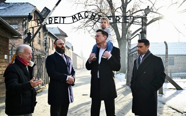 Holocaust survivor Gidon Lev, European Jewish Association Chairman Rabbi Menachem Margolin, Elon Musk with son, and Ben Shapiro stand together at the entrance of Auschwitz, Jan. 22, 2024. (JTA: Courtesy EJA) Holocaust survivor Gidon Lev, European Jewish Association Chairman Rabbi Menachem Margolin, Elon Musk with son, and Ben Shapiro stand together at the entrance of Auschwitz, Jan. 22, 2024. (JTA: Courtesy EJA)