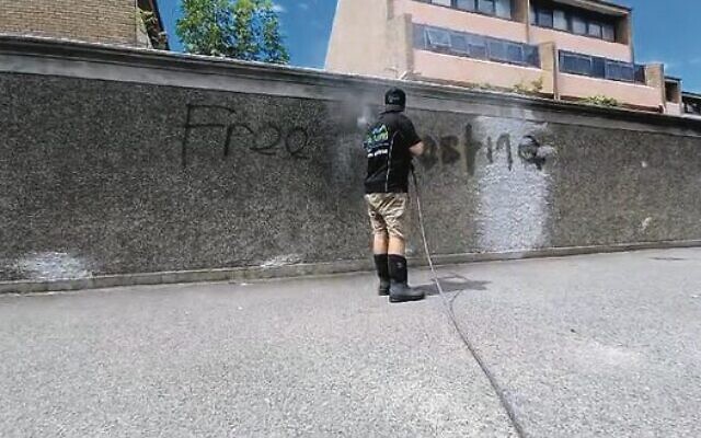 Heshy Adelist working to remove graffiti. Heshy Adelist working to remove graffiti.