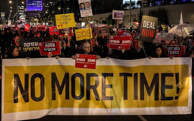 Demonstrators block a main road demanding an immediate deal for the release Israeli hostages held in the Gaza Strip by Palestinian terrorists, during a protest near the Defense Ministry in Tel Aviv on February 1, 2024. (The Times of Israel: Ahmad Gharabli/AFP)