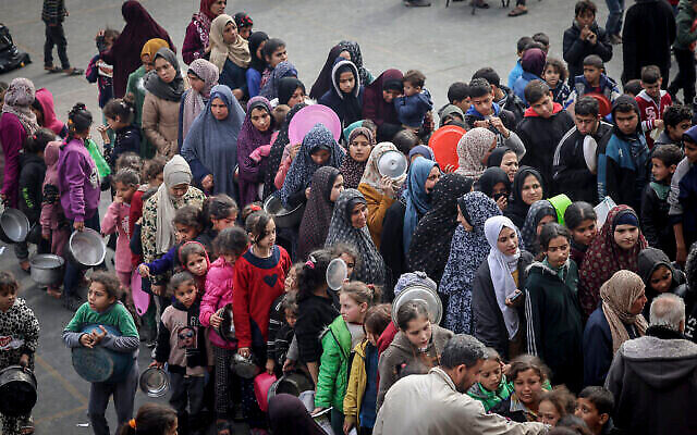 Displaced Palestinians gather to receive food at a government school in Rafah in the southern Gaza Strip on February 19, 2024. (The Times of Israel: Mohammed Abed/AFP) Displaced Palestinians gather to receive food at a government school in Rafah in the southern Gaza Strip on February 19, 2024. (The Times of Israel: Mohammed Abed/AFP)