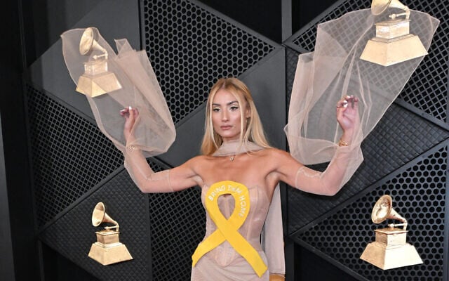 Singer and influencer Montana Tucker arrives for the 66th Annual Grammy Awards at the Crypto.com Arena in Los Angeles on February 4, 2024, wearing a dress with a yellow ribbon meant to call attention to the Israeli hostages in Gaza. (JTA: Photo by Robyn Beck/AFP via Getty Images) Singer and influencer Montana Tucker arrives for the 66th Annual Grammy Awards at the Crypto.com Arena in Los Angeles on February 4, 2024, wearing a dress with a yellow ribbon meant to call attention to the Israeli hostages in Gaza. (JTA: Photo by Robyn Beck/AFP via Getty Images)