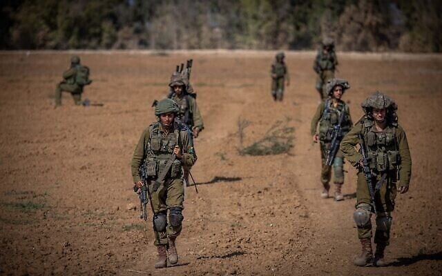 Israeli soldiers from the Netzah Yehuda Battalion patrol near the Israeli-Gaza border, October 20, 2023. (The Times of Israel: Yonatan Sindel/ Flash90) Israeli soldiers from the Netzah Yehuda Battalion patrol near the Israeli-Gaza border, October 20, 2023. (The Times of Israel: Yonatan Sindel/ Flash90)