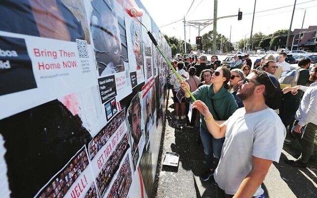 Community members redoing the hostage posters mural in St Kilda last Tuesday after it was vandalised overnight. Photo: Peter Haskin Community members redoing the hostage posters mural in St Kilda last Tuesday after it was vandalised overnight. Photo: Peter Haskin