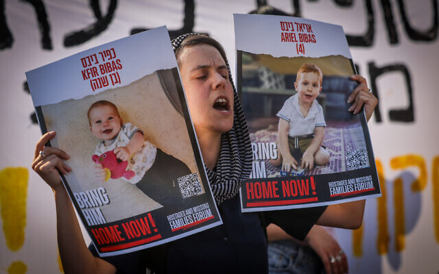 An Israeli student holds pictures of hostages during a protest calling for their release near the Knesset in Jerusalem, June 13, 2024. (The Times of Israel: Chaim Goldberg/Flash90) An Israeli student holds pictures of hostages during a protest calling for their release near the Knesset in Jerusalem, June 13, 2024. (The Times of Israel: Chaim Goldberg/Flash90)