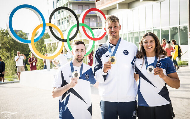 Gymnast Artem Dolgopyat (left) and sailors Tom Reuveny (center) and Sharon Kantor pose with their silver, gold and silver Olympic medals in Paris on August 4, 2024. (The Times of Israel: Olympic Committee of Israel) Gymnast Artem Dolgopyat (left) and sailors Tom Reuveny (center) and Sharon Kantor pose with their silver, gold and silver Olympic medals in Paris on August 4, 2024. (The Times of Israel: Olympic Committee of Israel)