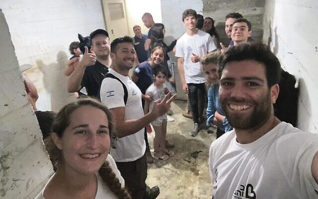 Shlomo Lampert (right) with locals in a renovated shelter. Photo: Times Of Israel Shlomo Lampert (right) with locals in a renovated shelter. Photo: Times Of Israel