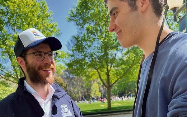 Rabbi Bochi Broh helps Melbourne University business administration student Jasper Sherman lay tefillin. Rabbi Bochi Broh helps Melbourne University business administration student Jasper Sherman lay tefillin.