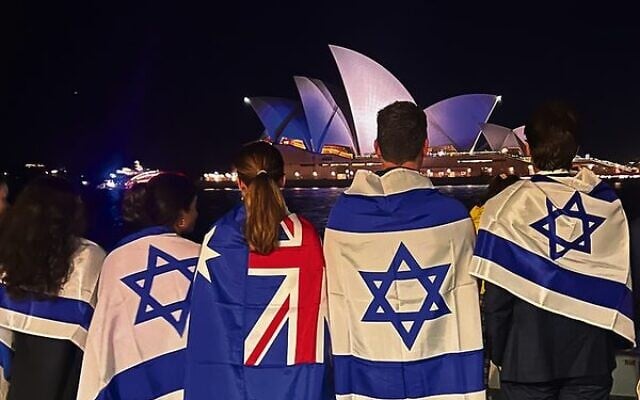 A group of Jewish supporters stand opposite the Sydney Opera House as it is lit up in solidarity with Israel following the October 7 Hamas-led massacre A group of Jewish supporters stand opposite the Sydney Opera House as it is lit up in solidarity with Israel following the October 7 Hamas-led massacre