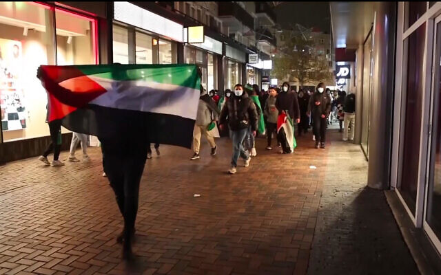 In this image taken from video, people march with Palestinian flags near the Ajax stadium in Amsterdam, the Netherlands, Thursday, November 7, 2024. (The Times of Israel: AP Photo InterVision) In this image taken from video, people march with Palestinian flags near the Ajax stadium in Amsterdam, the Netherlands, Thursday, November 7, 2024. (The Times of Israel: AP Photo InterVision)
