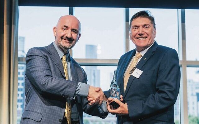 Professor Simon Wilkie (left) presents Mike Zervos with his award. Professor Simon Wilkie (left) presents Mike Zervos with his award.