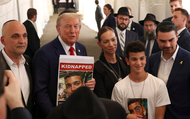 Then-former US president Donald Trump poses for photos with family members of Hamas hostage Edan Alexander, after visiting the gravesite of Rabbi Menachem Mendel Schneerson in New York, October 7, 2024. (The Times of Israel: AP Photo/ Yuki Iwamura) Then-former US president Donald Trump poses for photos with family members of Hamas hostage Edan Alexander, after visiting the gravesite of Rabbi Menachem Mendel Schneerson in New York, October 7, 2024. (The Times of Israel: AP Photo/ Yuki Iwamura)