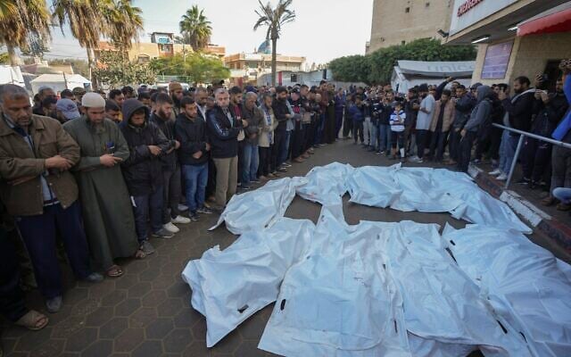 Palestinians pray over the bodies of people killed in an Israeli army strike against Hamas in the Nuseirat refugee camp, at the Al-Aqsa Martyrs hospital in Deir al-Balah, Gaza Strip, December 12, 2024. (The Times of Israel: Abdel Kareem Hana/AP) Palestinians pray over the bodies of people killed in an Israeli army strike against Hamas in the Nuseirat refugee camp, at the Al-Aqsa Martyrs hospital in Deir al-Balah, Gaza Strip, December 12, 2024. (The Times of Israel: Abdel Kareem Hana/AP)