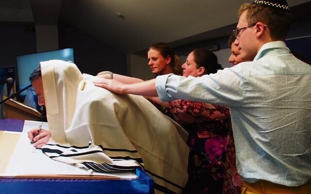 From left, Tamara, Sharona, Naomi and Rafael Ungar join sofer Rabbi Gustavo Suraszki as he inscribes the new Sefer Torah. Photo: Bev Rosenberg From left, Tamara, Sharona, Naomi and Rafael Ungar join sofer Rabbi Gustavo Suraszki as he inscribes the new Sefer Torah. Photo: Bev Rosenberg