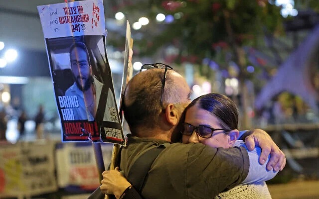 Demonstrators embrace each other after the ceasefire and hostage release agreement between Israel and Hamas was reported, Tel Aviv, January 15, 2025. (The Times of Israel: Jack GUEZ / AFP) Demonstrators embrace each other after the ceasefire and hostage release agreement between Israel and Hamas was reported, Tel Aviv, January 15, 2025. (The Times of Israel: Jack GUEZ / AFP)