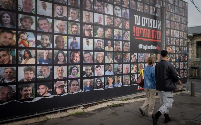 People walk past pictures of the hostages held by Hamas in Gaza, in Jerusalem, January 12, 2025. (The Times of Israel: Chaim Goldberg/Flash90) People walk past pictures of the hostages held by Hamas in Gaza, in Jerusalem, January 12, 2025. (The Times of Israel: Chaim Goldberg/Flash90)